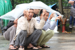 Người dân mặc áo mưa theo dõi phiên xử Đặng Văn Hiến