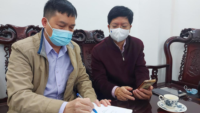 Ông Nguyễn Trọng Khoa (bên phải) đang theo dõi thông tin dịch bệnh.