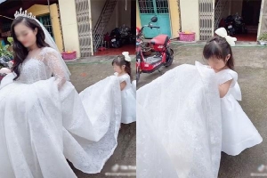 Nhói lòng trước hình ảnh con gái nhỏ buồn thiu, nâng váy tiễn mẹ đi lấy chồng