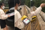 Cô gái quay video đi ô tô lên cầu vứt ảnh cưới xuống sông, dân tình chỉ tích