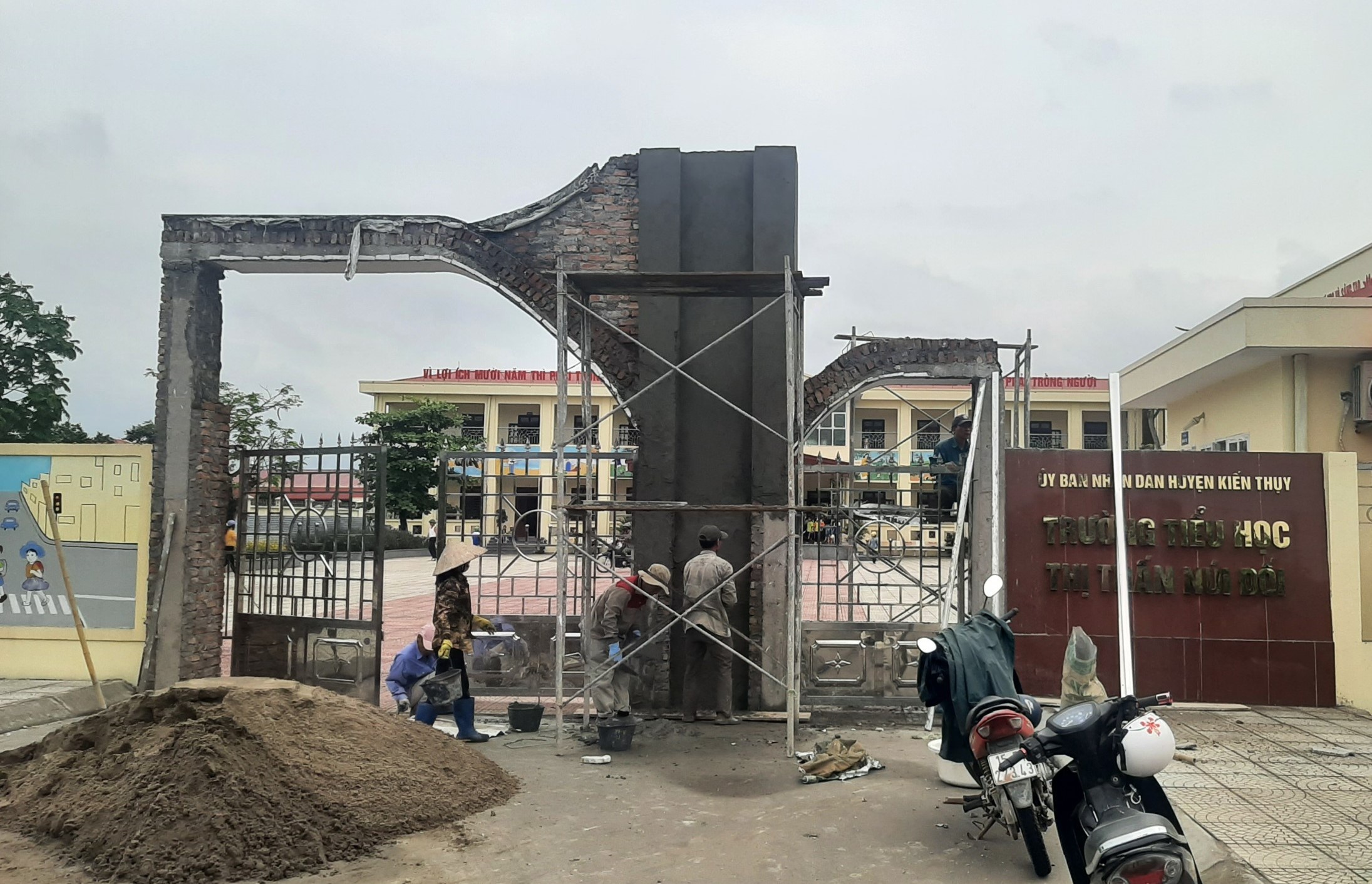 Đơn vị thi công khắc phục, sửa chữa cổng trường sau sự cố. Ảnh: Nguyễn Dương.